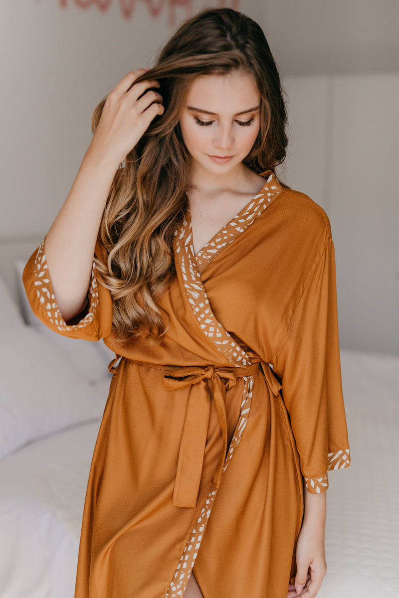 Tan robe with floral tan trim