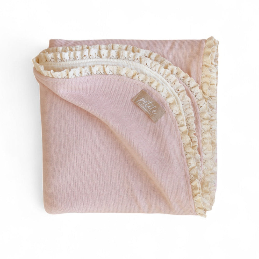 Pink blanket with white lace trim 