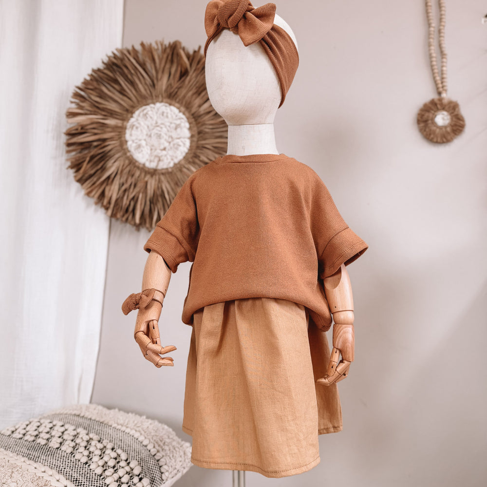 
                      
                        Arabella baby dress / linen - cinnamon
                      
                    